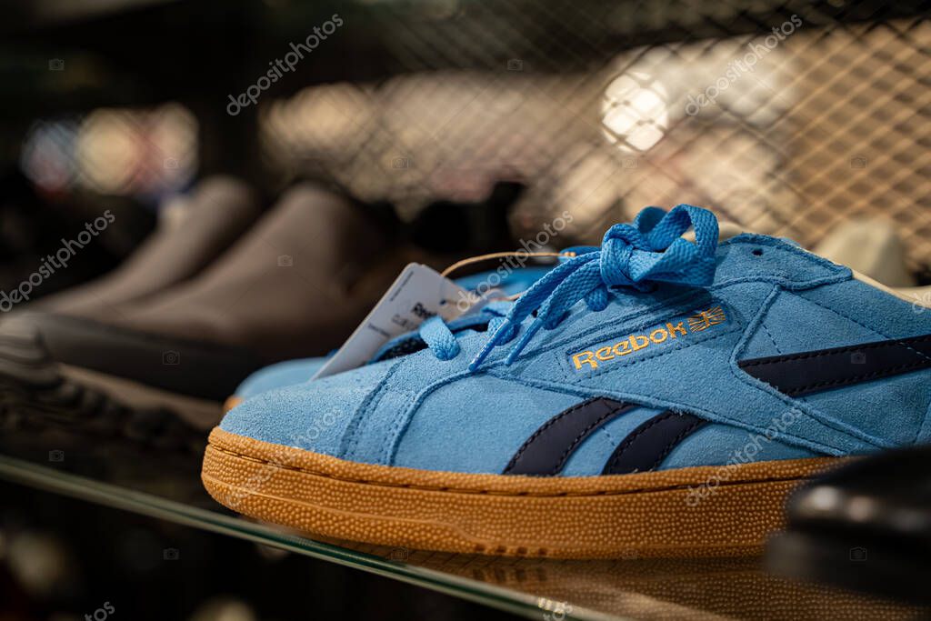 Close up of blue Reebok sneaker with gum sole on display shelf. Toronto, Canada - September 20, 2025.