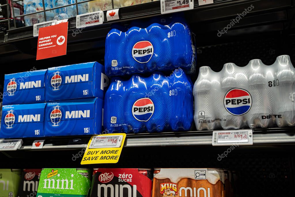 View of Pepsi and Diet Pepsi multipacks on supermarket shelf with promotional signs. Toronto, Canada - September 20, 2025.