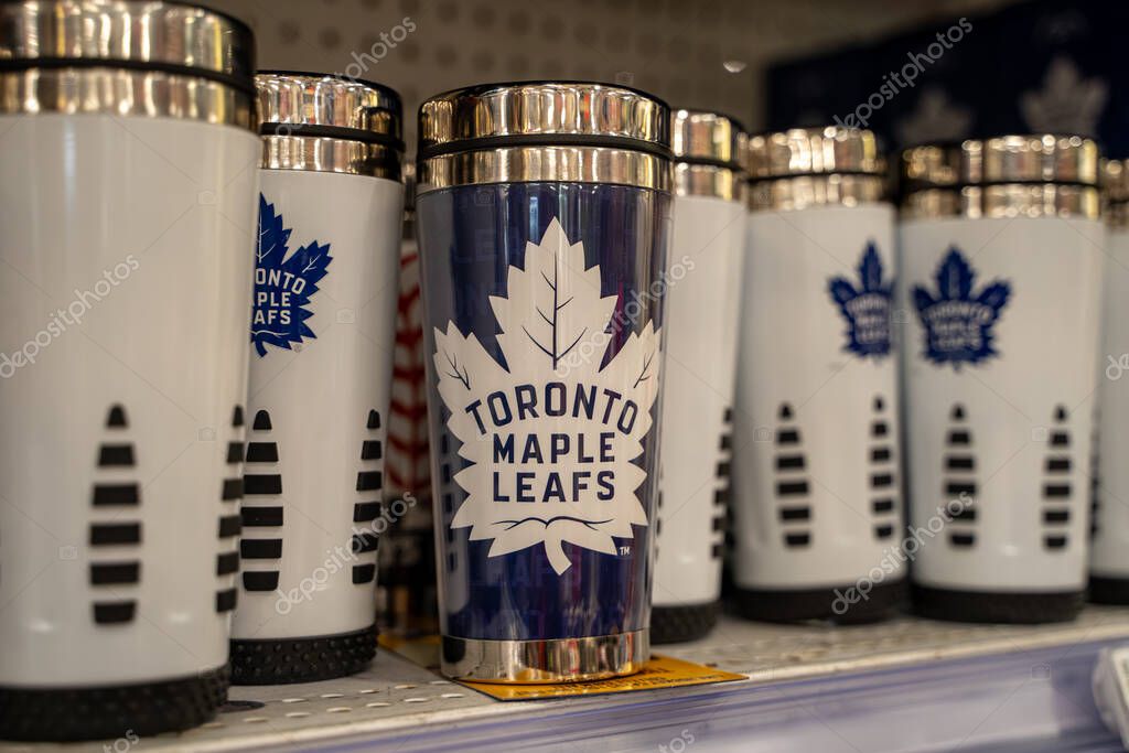 Toronto Maple Leafs travel mugs with team logo displayed on store shelf. Toronto, Canada - September 24, 2025.