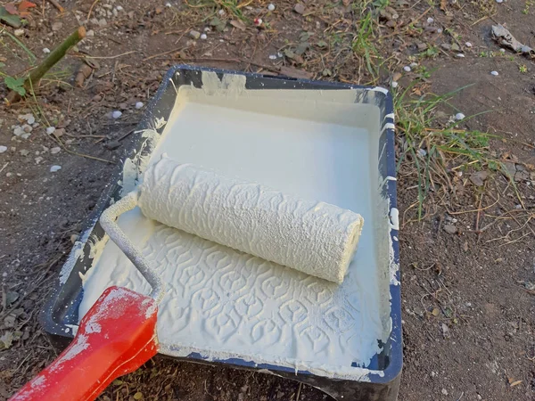 Rolo mergulhado em tinta pronta para pintar — Fotografia de Stock