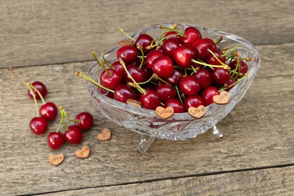 Love sweet cherries concept. Cherries on a wooden background