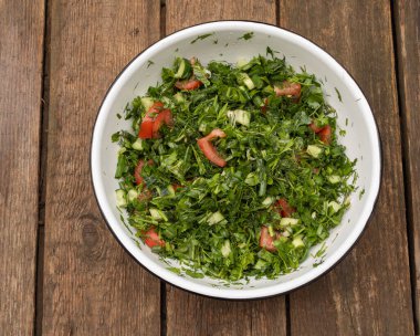 Çeşitli otlardan oluşan yaz salatası - sağlığa iyi gelir. Ahşap Arkaplan.