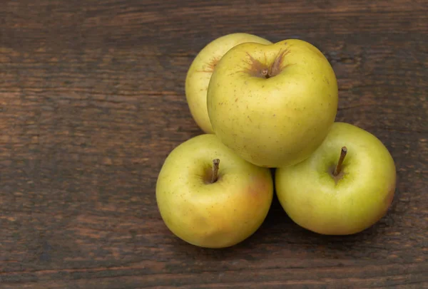 Fresh apples on a wooden background. White apples.