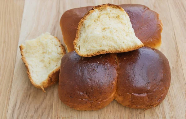 Tasty and fresh brioche buns on wooden background close up. Good to eat with tea — Stock Photo, Image