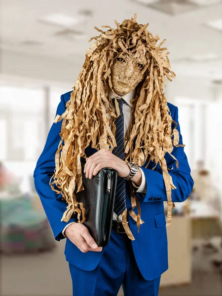 Man in a business blue suit is standing with a folder for documents and in a goblin mask. Concept of hypocrisy and deception in the office. Halloween