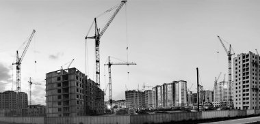 Barnaul. - Rusya. 18 Haziran 2020. Geceleri güçlendirilmiş beton ve tuğladan evler inşa ediliyor. Vinçlerin çalışması, evlerin inşası. Hevesliler Sokağı. Panoramik. Siyah ve beyaz resim