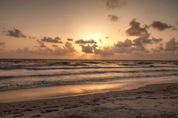 stock image Golden sunset over the white sand of Clam Pass Beach to the ocean in Naples, Florida