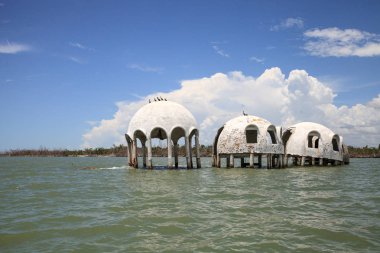 Blue sky over the Cape Romano dome house ruins in the Gulf Coast of Florida clipart