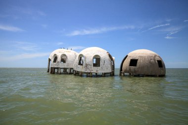 Blue sky over the Cape Romano dome house ruins in the Gulf Coast of Florida clipart