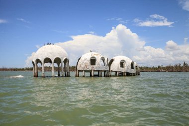 Blue sky over the Cape Romano dome house ruins in the Gulf Coast of Florida clipart