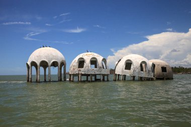 Blue sky over the Cape Romano dome house ruins in the Gulf Coast of Florida clipart