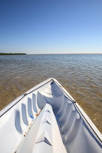 Kayak glides through water along the coastline of Marco Island, Florida near Tigertail Beach.