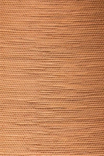 Tan textured bamboo fabric background tied together in knots.