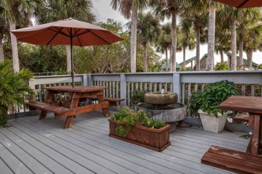 Picnic tables and umbrellas on a beach on Marco Island clipart