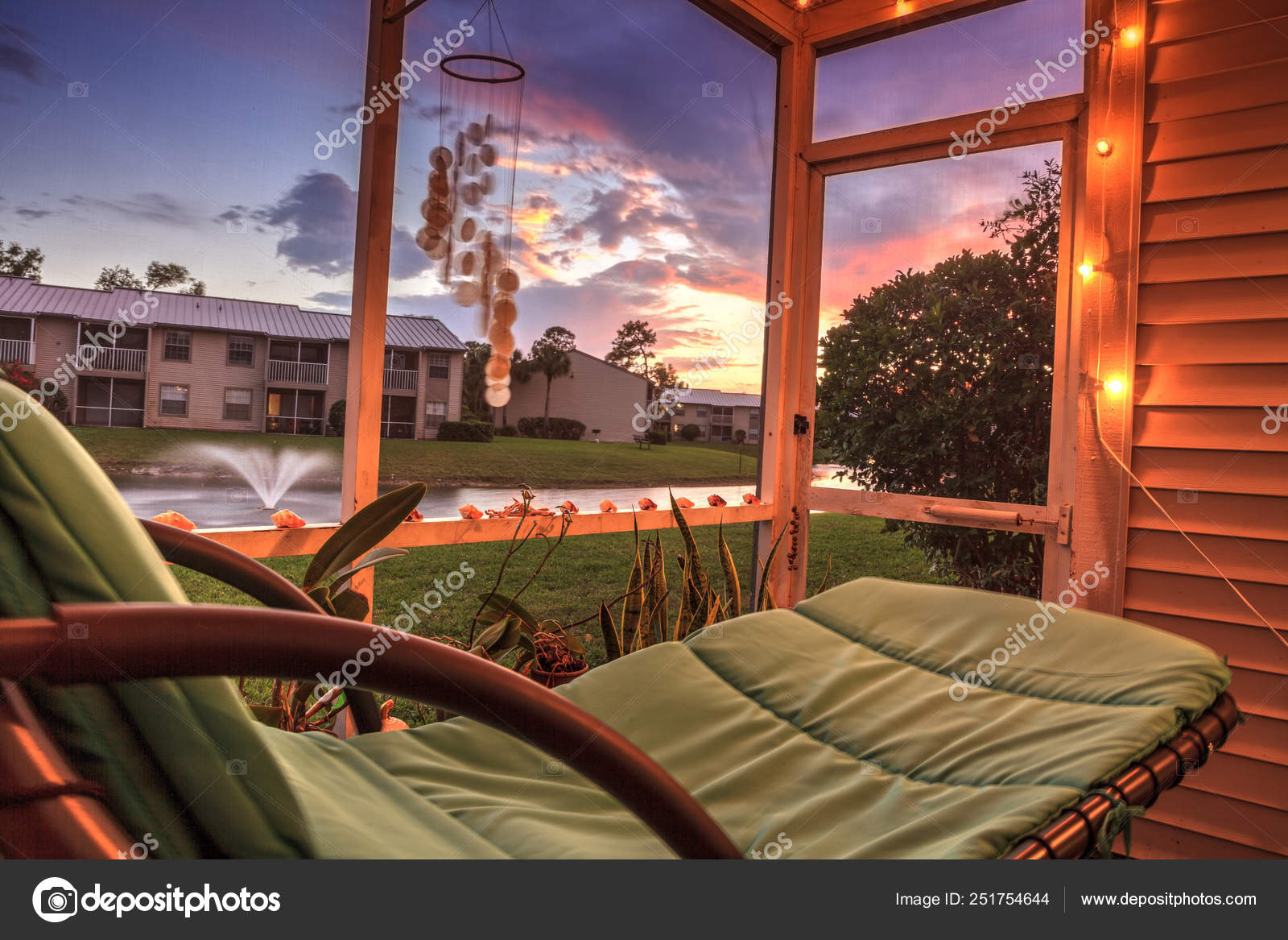 Swinging Lounge Chair On A Lanai At Sunset As It Overlooks A