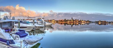 Sunrise over the boats in Esplanade Harbor Marina in Marco Islan clipart