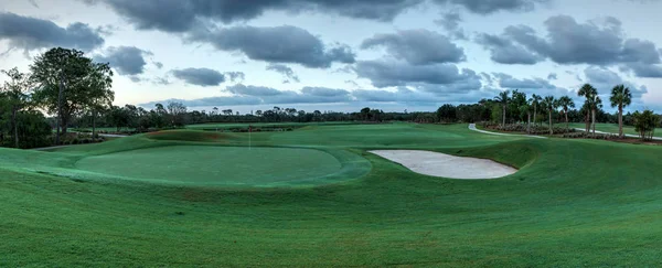 Yemyeşil yeşil çimenlerin üzerinde bir yol için bir golf arabası ile golf sahası — Stok fotoğraf