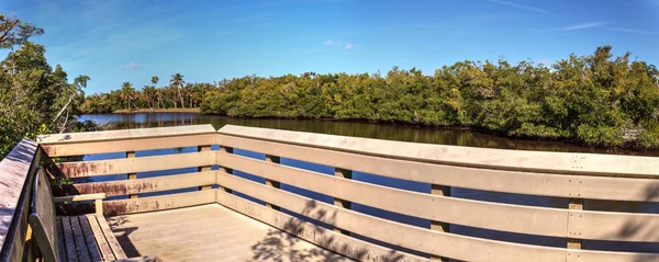 Blue sky and clouds over a bridge that crosses Henderson Creek, — Stock Photo, Image