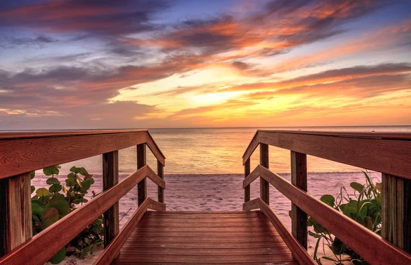 Boardwalk leading to a Sunset over North Gulf Shore Beach