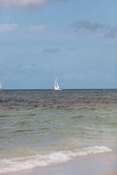 Sailboat glides through the ocean off Naples Beach