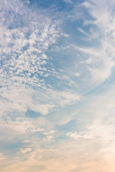 Sunset sky with white clouds and bright sky blue background.