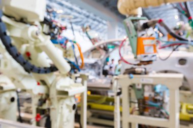 Araba üretim fabrikası Makina ve robot otomat tarafından iç arka plan bulanık. iş araba sanayi deneyimi kullanmak olabilir.