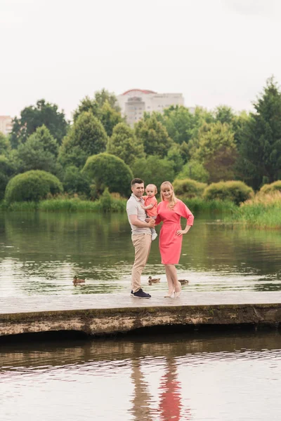 Family walk in the park. Family walks in the park. Man, woman and child in nature. Picture.