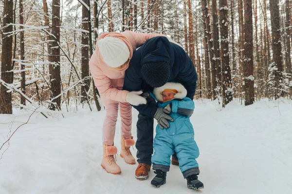 Walking family with a child. Family walks in nature in winter. Winter family walk in nature. A lot of snow.