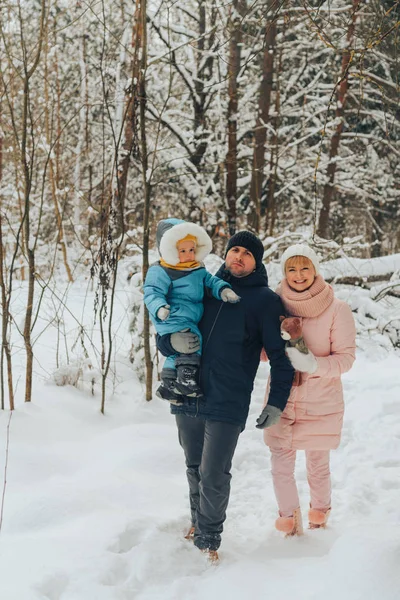 Walking family with a child. Family walks in nature in winter. Winter family walk in nature. A lot of snow. Royalty Free Stock Photos