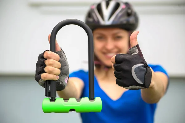 Girl with bicycle  lock. Bicycle U- lock.