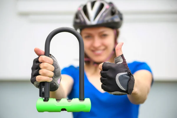 Girl with bicycle  lock. Bicycle U- lock.