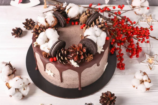 Christmas  cake with flowers and chocolate. Wedding details - wedding cake.  Winter cake with cones