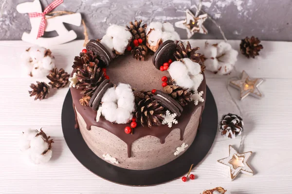 Christmas  cake with flowers and chocolate. Wedding details - wedding cake.  Winter cake with cones