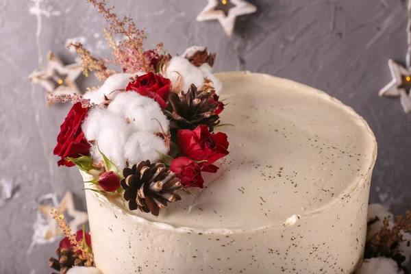 Christmas  cake with flowers and chocolate. Wedding details - wedding cake.  Winter cake with cones