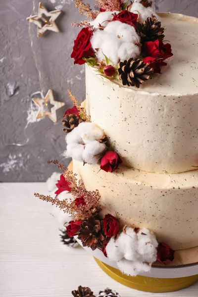 Christmas  cake with flowers and chocolate. Wedding details - wedding cake.  Winter cake with cones