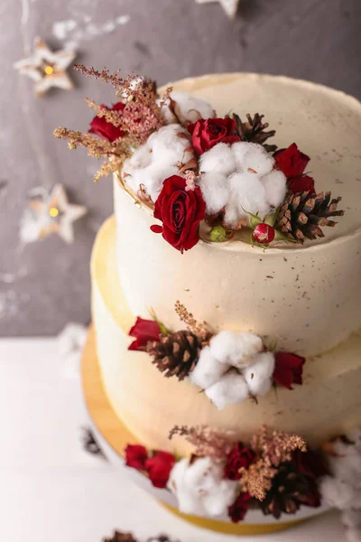 Christmas  cake with flowers and chocolate. Wedding details - wedding cake.  Winter cake with cones