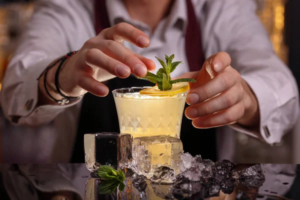  Barmen Fitzgerald kokteyl yapıyor. Fitzgerald alkol siyah zemin yüzeyinde kokteyl