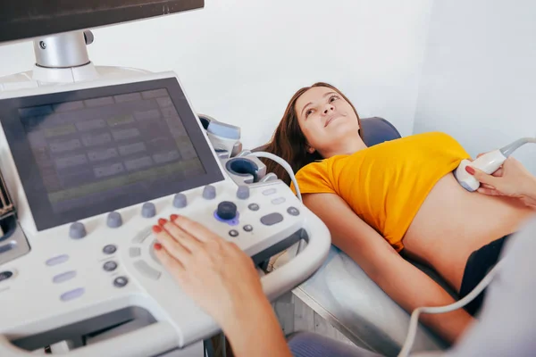 Doktor hasta yapıyor kadın abdominal ultrason. Ultrason tarayıcı bir doktor elinde. Tanılama. Ultrason 
