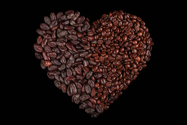 Roasted beans. Cocoa beans and coffee beans isolated on black background.