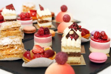 Tatil için çeşitli meyve pastaları. Meyveler, köpüğü, bisküvi ile tatlılar