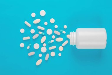 Çeşitli ilaç tıp hap, Tablet ve kapsüller ve şişe mavi zemin üzerine. Metin için yer kopyalayın