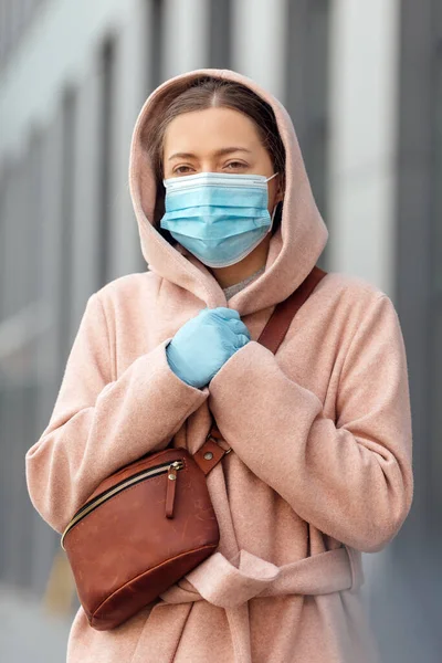 Woman wearing face protection in prevention for coronavirus outdoors