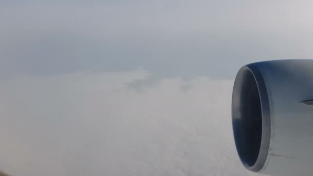 雲の上を飛んでいる間 タービンで飛行する飛行機の窓からの眺め — ストック動画