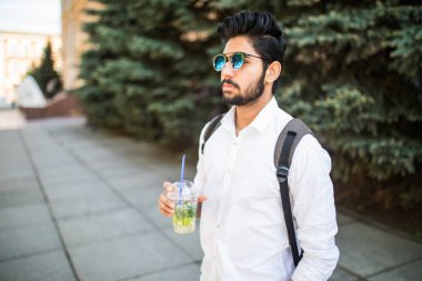 Neşeli Hintli Caddesi ve içki mojito yürüyüş güneş gözlüğü