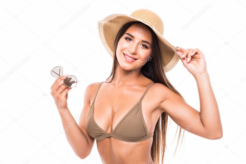 Half-length portrait of female wearing bikini, hat and sunglasses, isolated on white. Concept of summer holidays and traveling