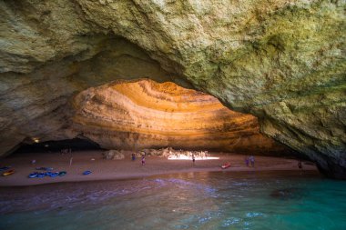 Benagil, Portugal - Juny, 2018: Benagil Cave Boat Tour inside Algar de Benagil, cave listed in the world's top 10 best caves. Algarve coast near Lagoa, Portugal. clipart