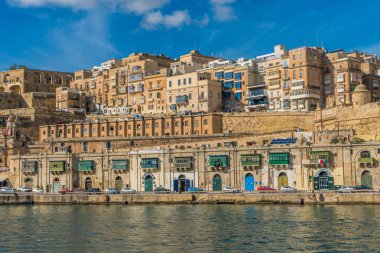 View on Valletta with its architecture from the sea on the boat clipart