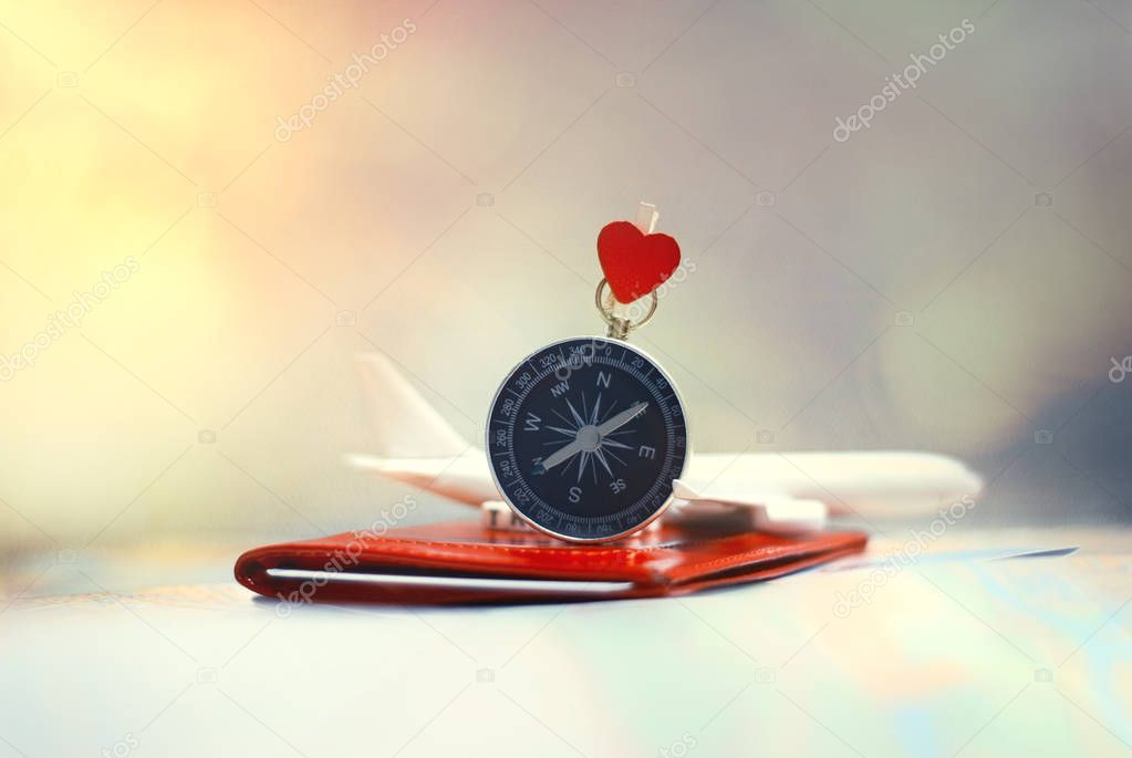 Time to Travel. Idea for tourism with an airplane, passport and tickets and compass with heart on a light background. Concept on the theme of flights