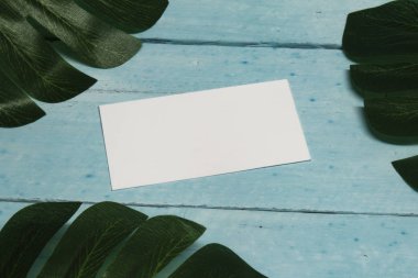 Gerçekçi Mock kadar kırmızı ahşap arka plan üzerinde, tropikal bitki ile kartvizit.