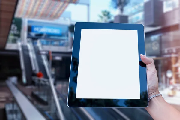 Mock up Tablet in hand closeup on airport background. Concept on the theme of air travel